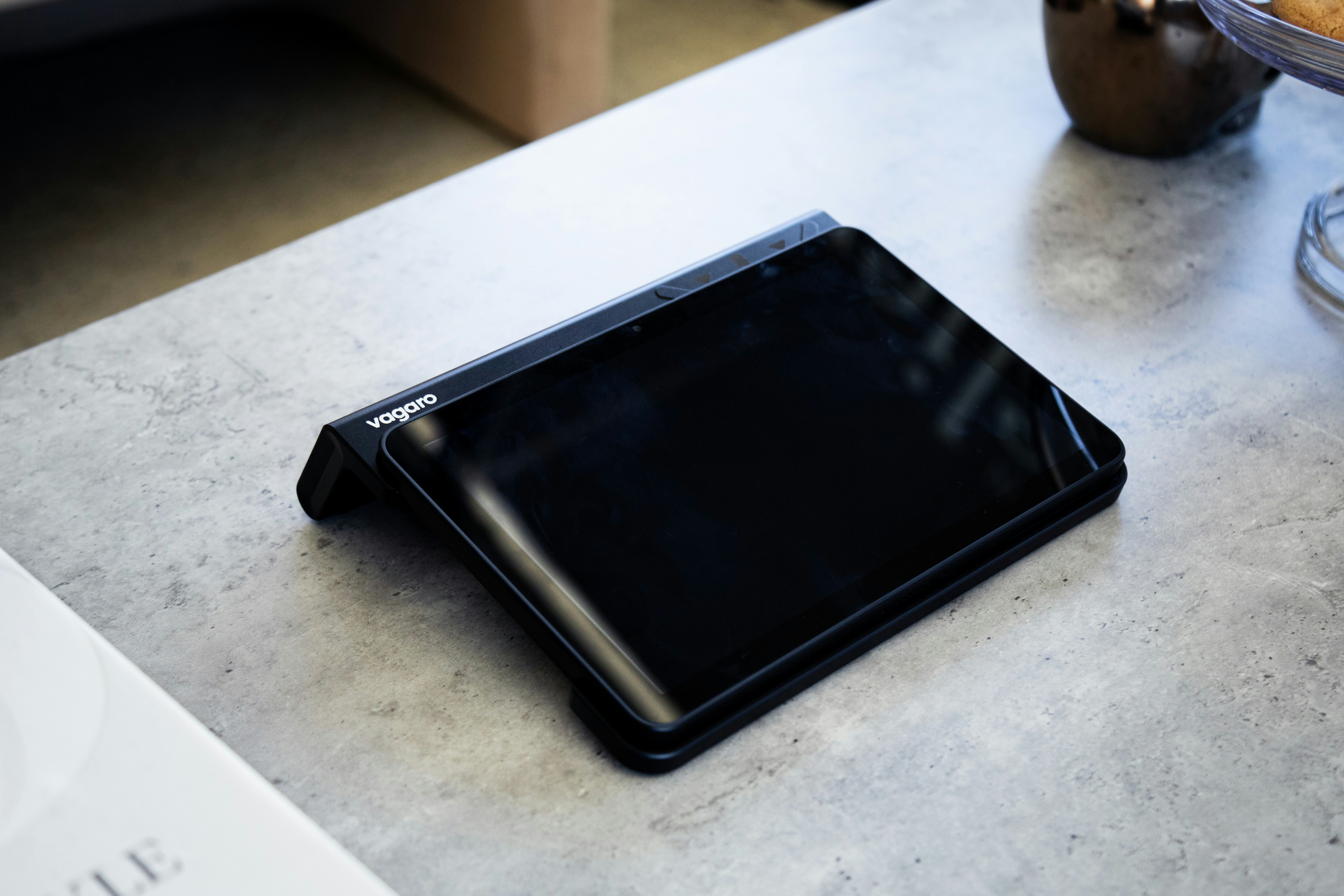 Vagaro PayPro Mini on a front desk surrounded by accessories