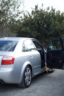 A woman exits her car.