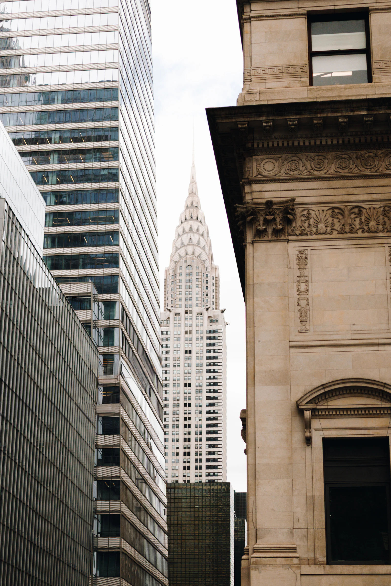 The Chrysler Building rising above Lexington Avenue, framed by neighboring buildings