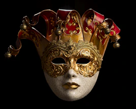A decorative venetian mask with a jester's hat.