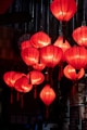 Red lanterns illuminate a dark room.