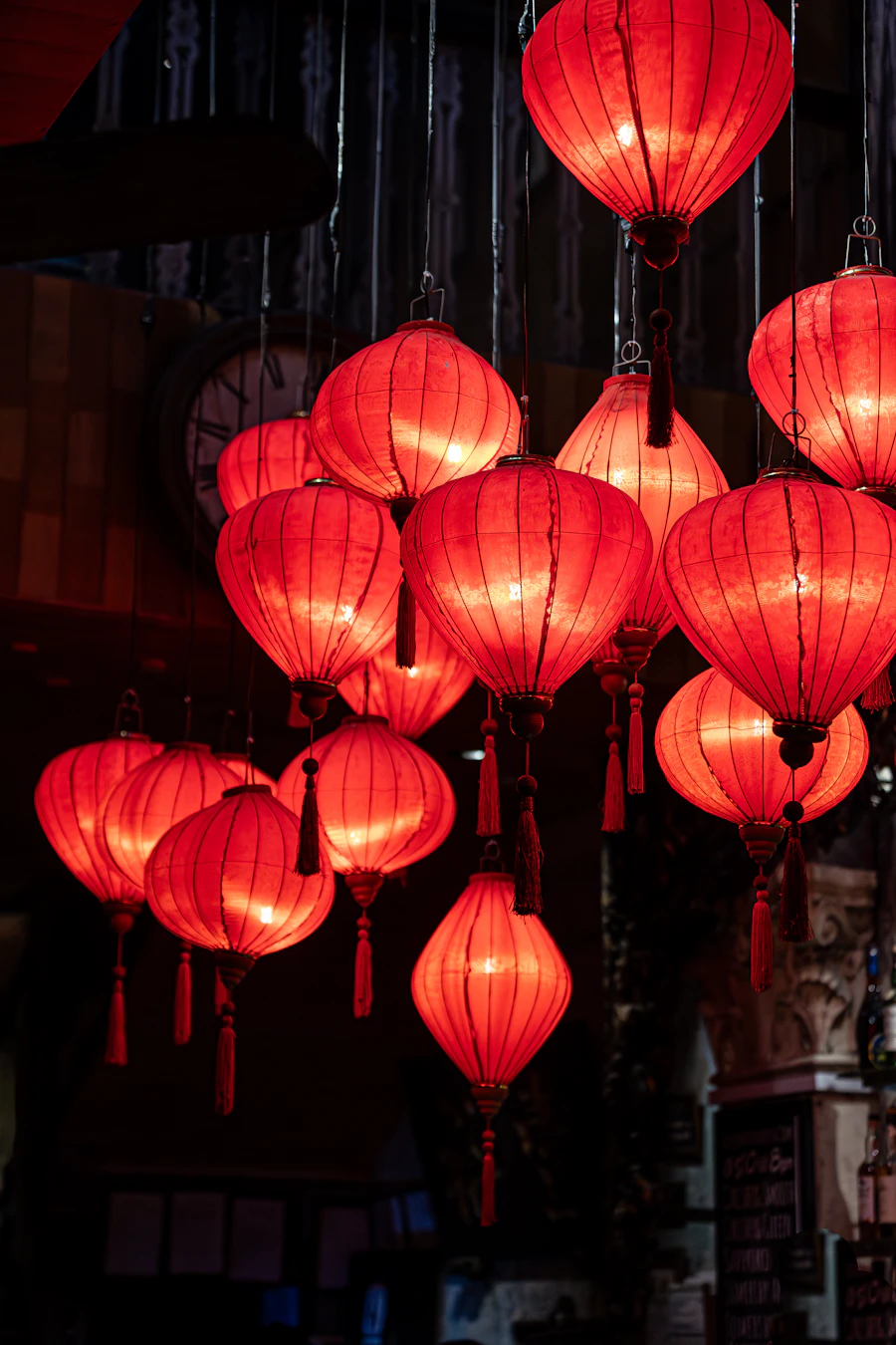 Red paper lanterns glowing in a dark room