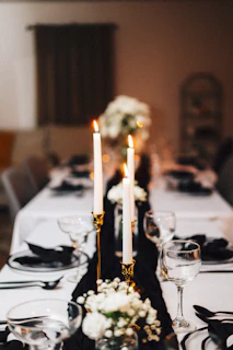 Elegant dinner table is set with candles.