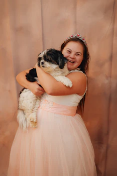 A girl and her dog are happy together.