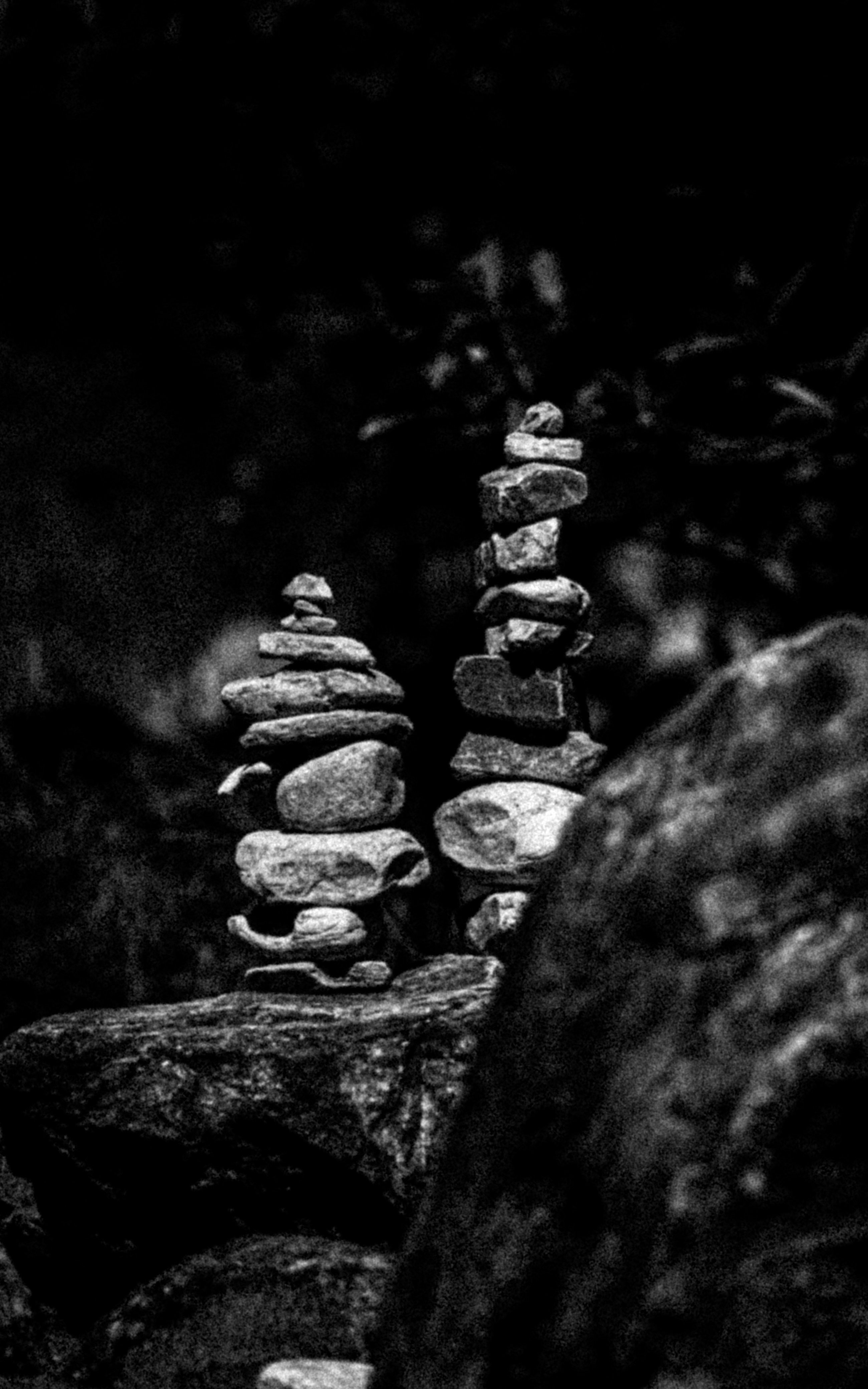 Stacked stones are artfully balanced in nature.