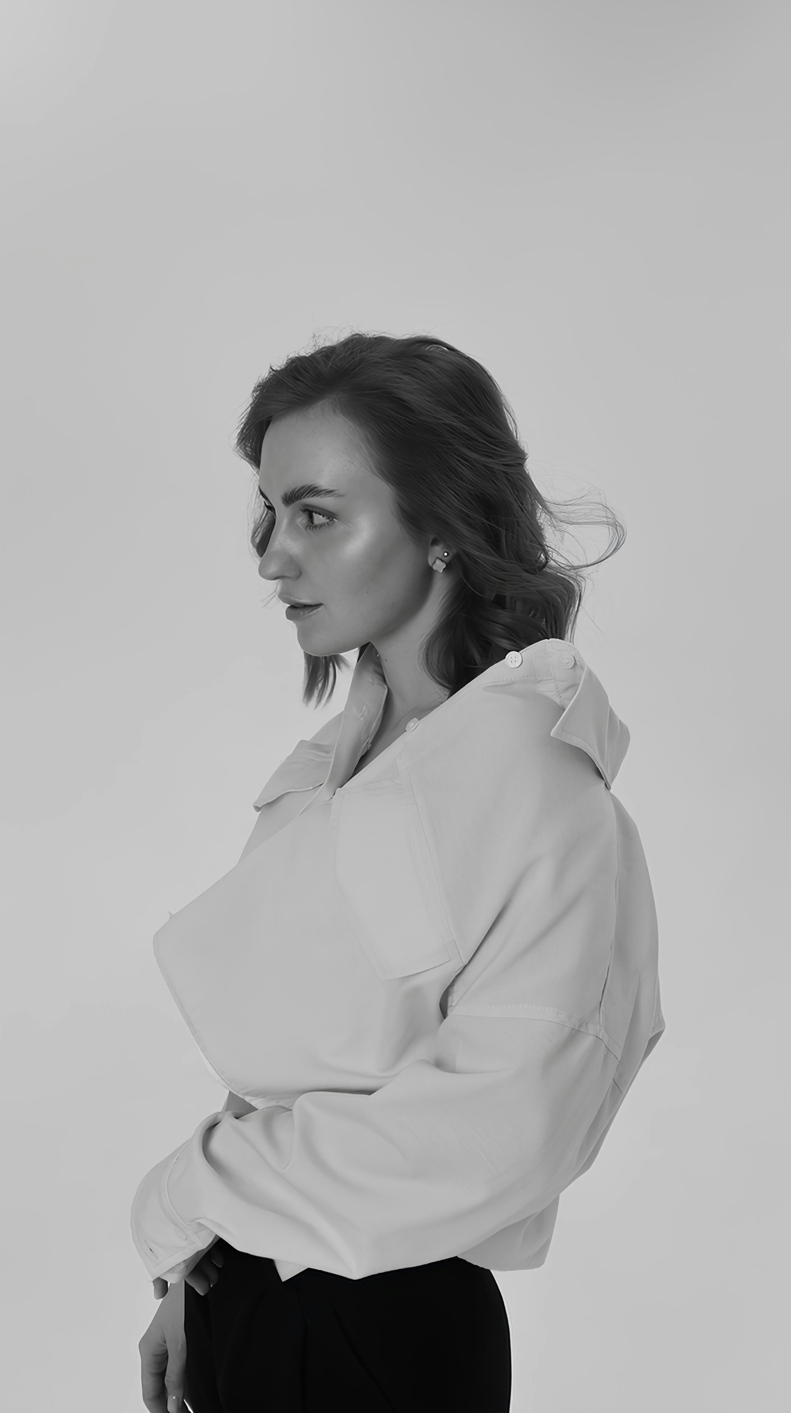 Woman poses in a black and white studio shot.
