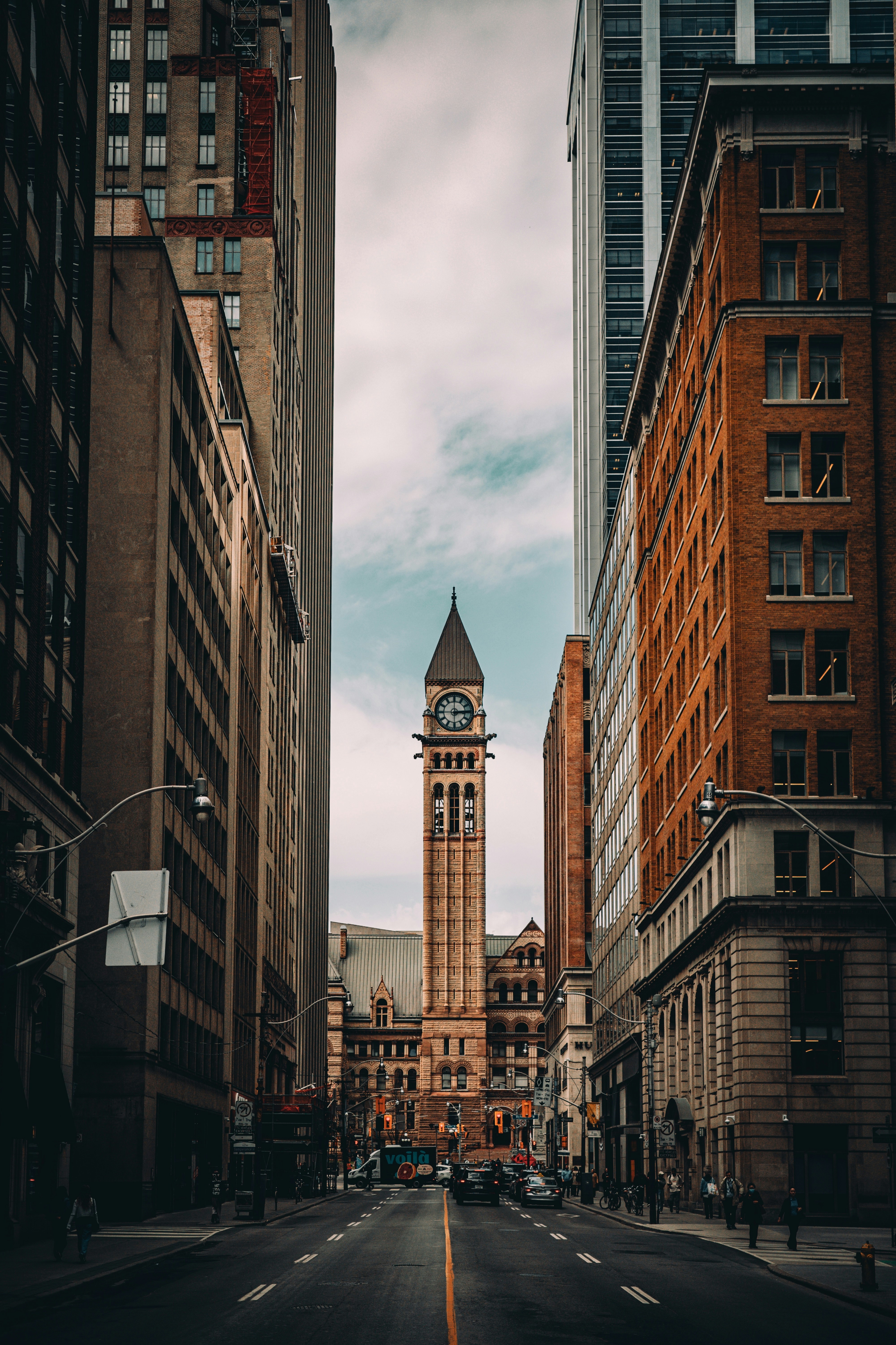 Buildings frame a view of a clock tower.