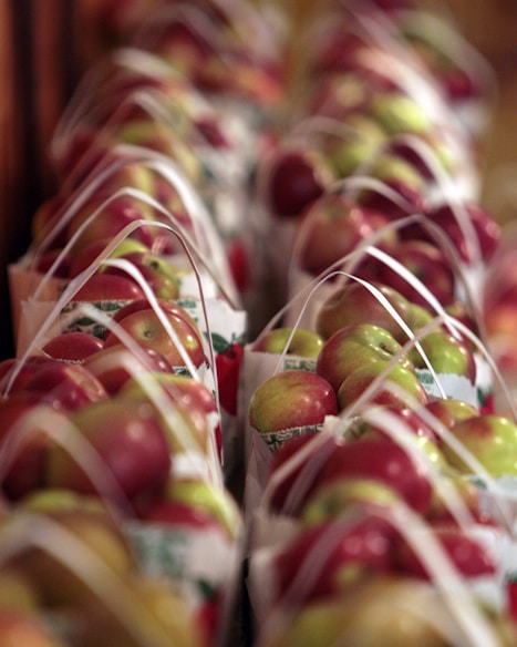 Apples are arranged in baskets.