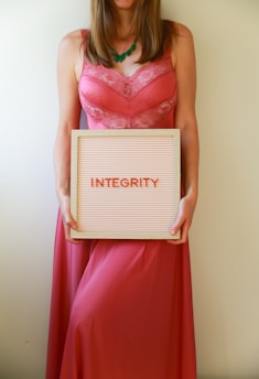 Woman holds a sign that says "integrity".