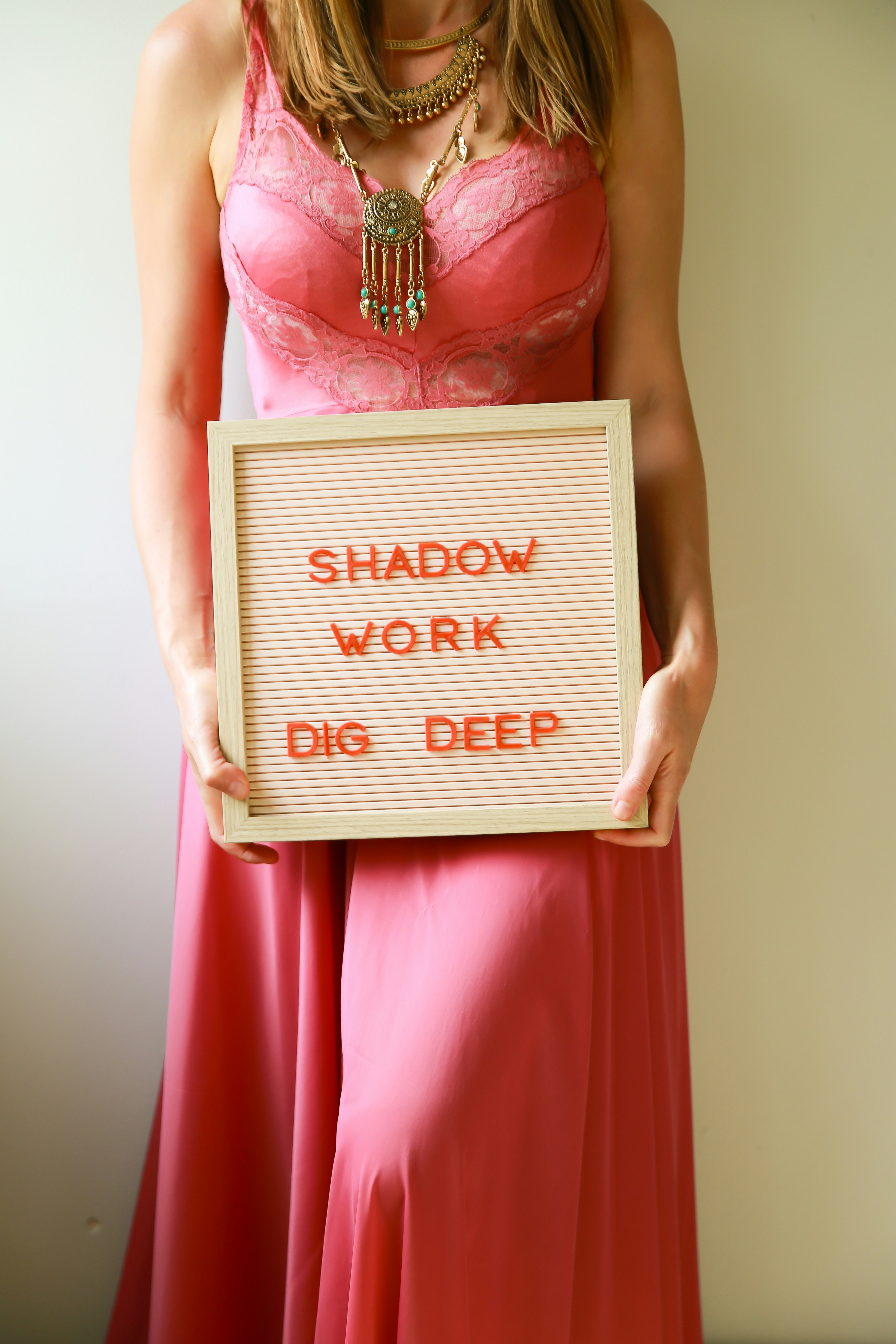 Woman holds a sign about shadow work.