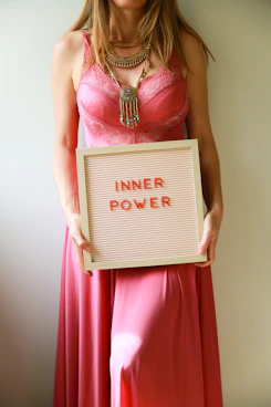 Woman holds sign with "inner power" message