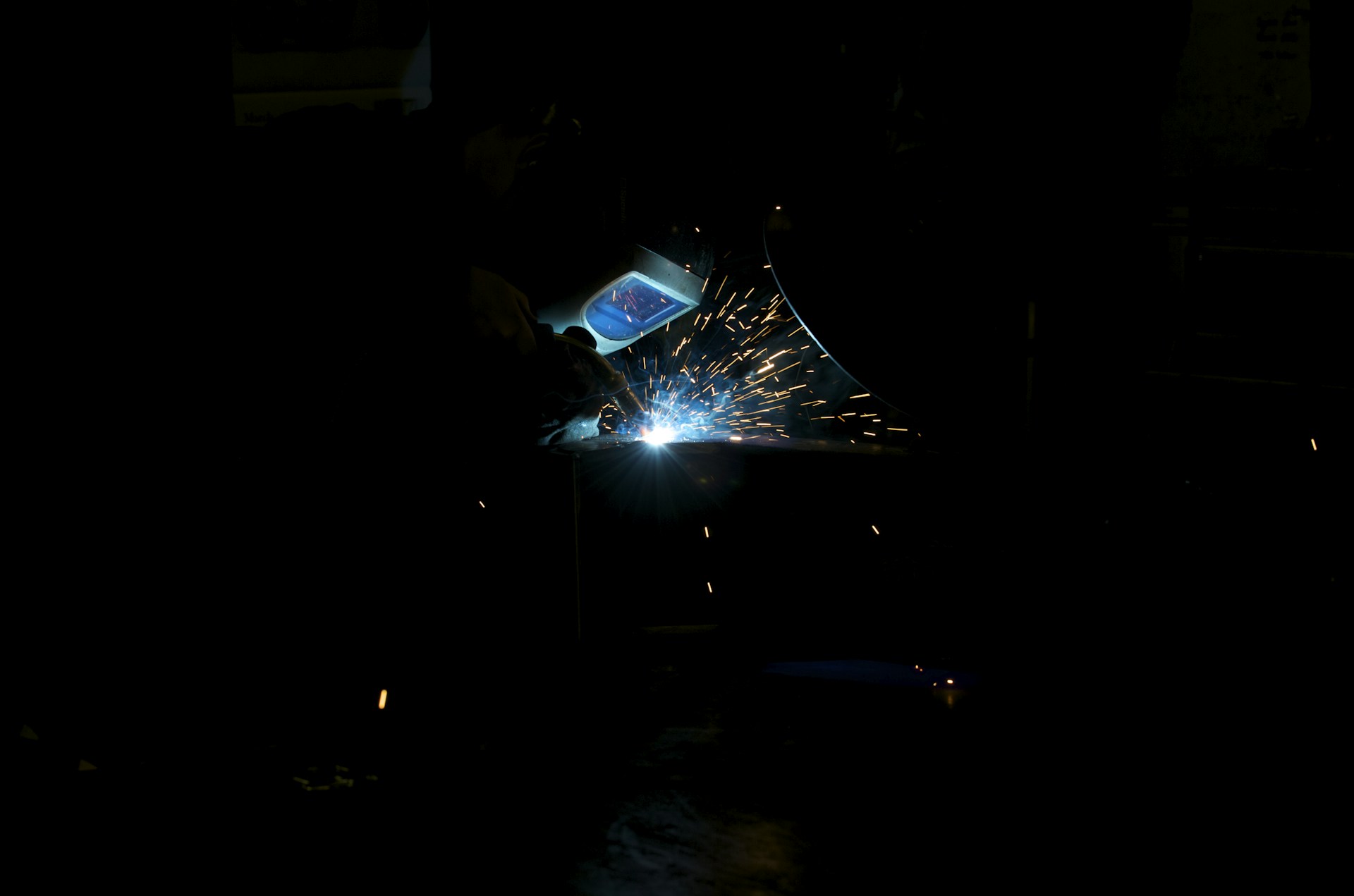 Welding sparks brightly in the dark.