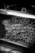 Metal springs are stacked in a warehouse.