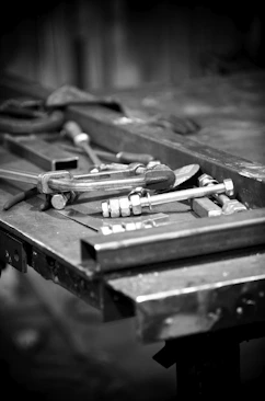 Tools and steel sit on a work table.