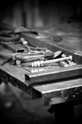 Tools and steel sit on a work table.
