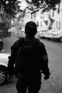 A policeman walks away down a street.
