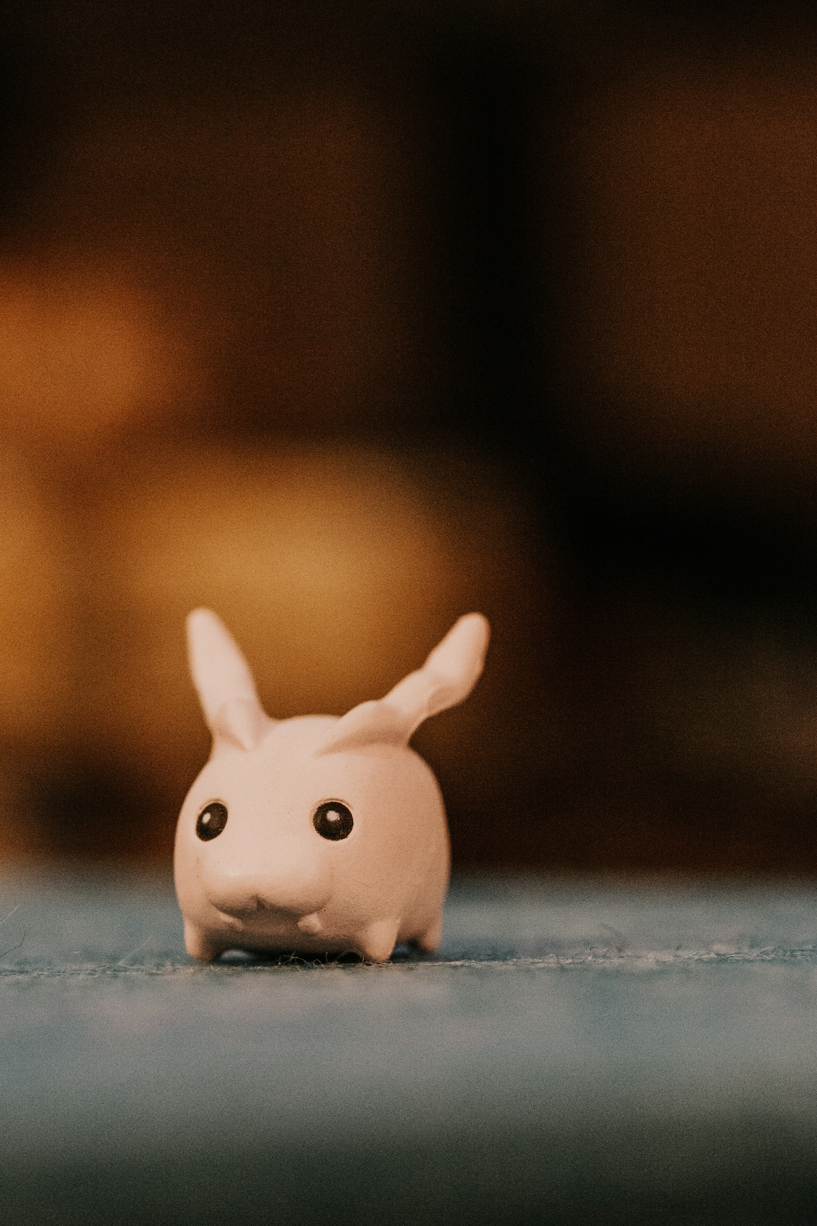 A small, cute, white rabbit figure is standing.