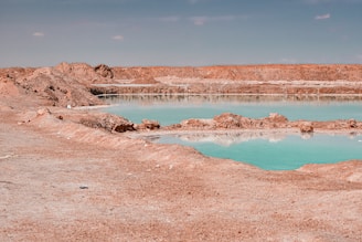 Turquoise water reflects across a desolate landscape.