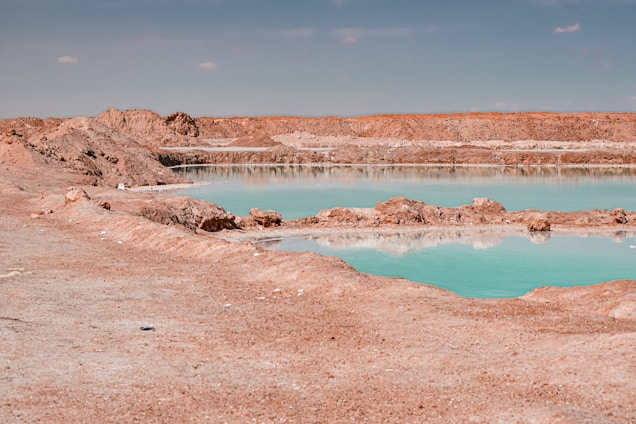 Turquoise water reflects across a desolate landscape.
