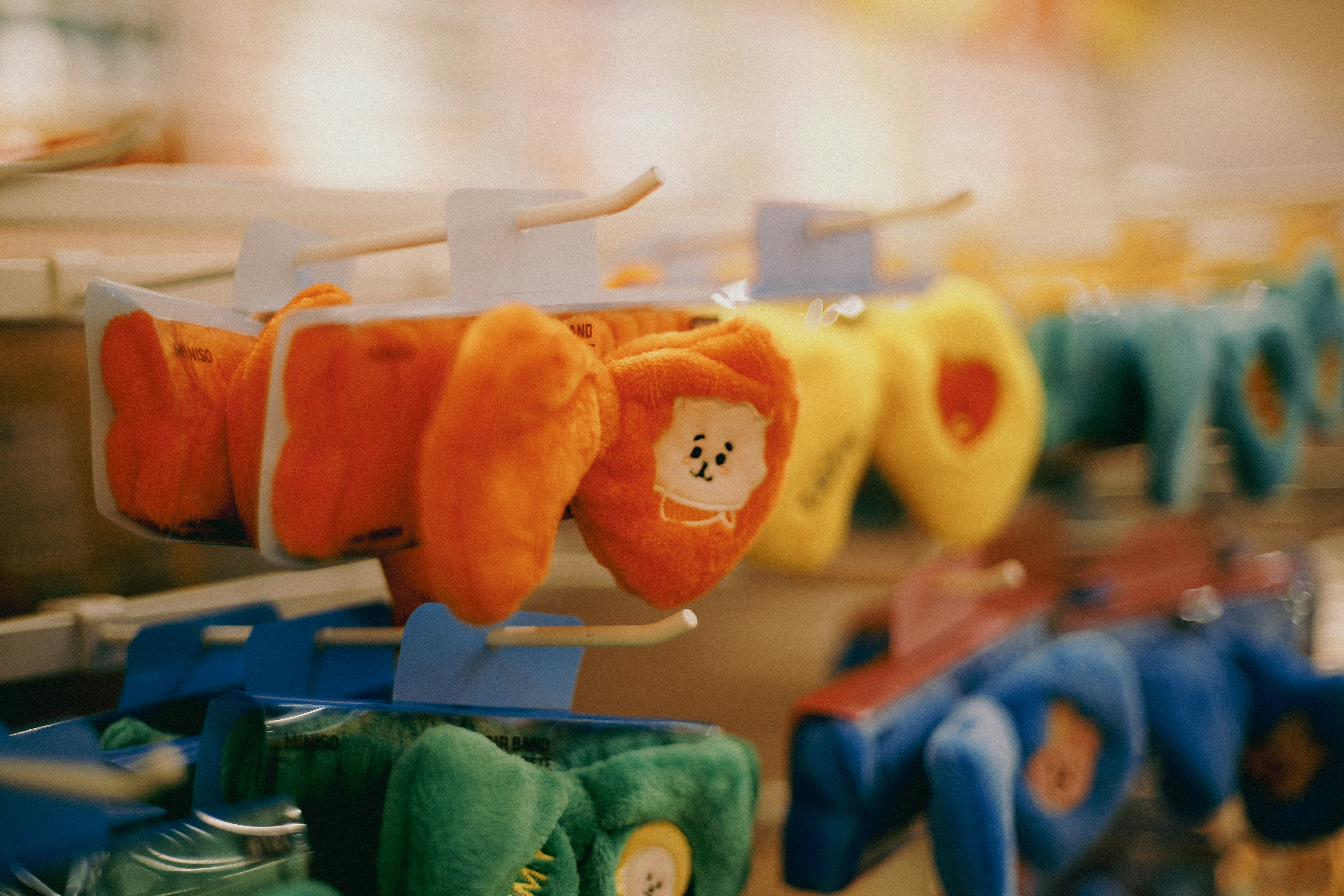 Stuffed toys hang on display in a store.