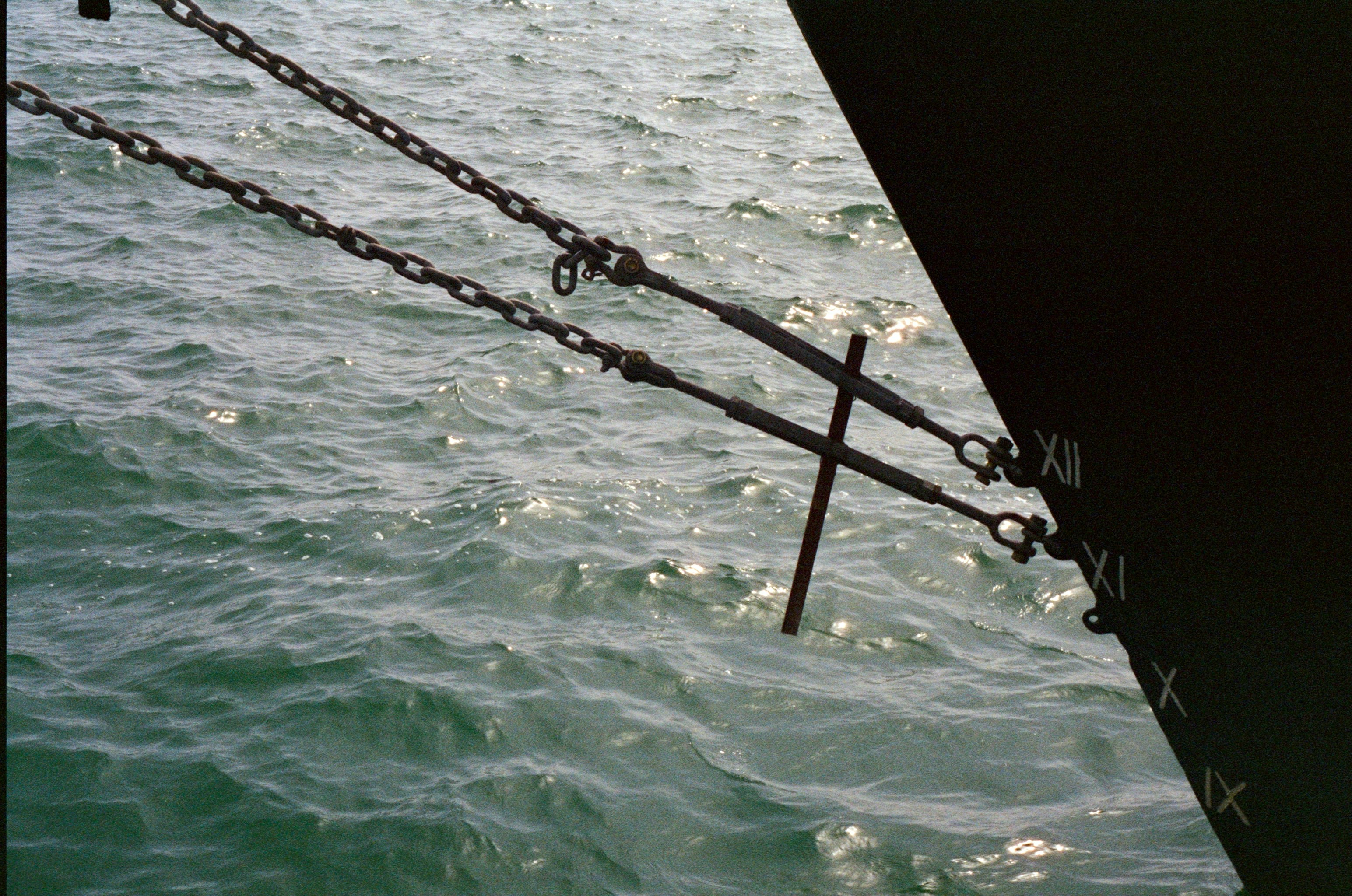 showing anchors being carefully lowered from a dock - anchor floating dock