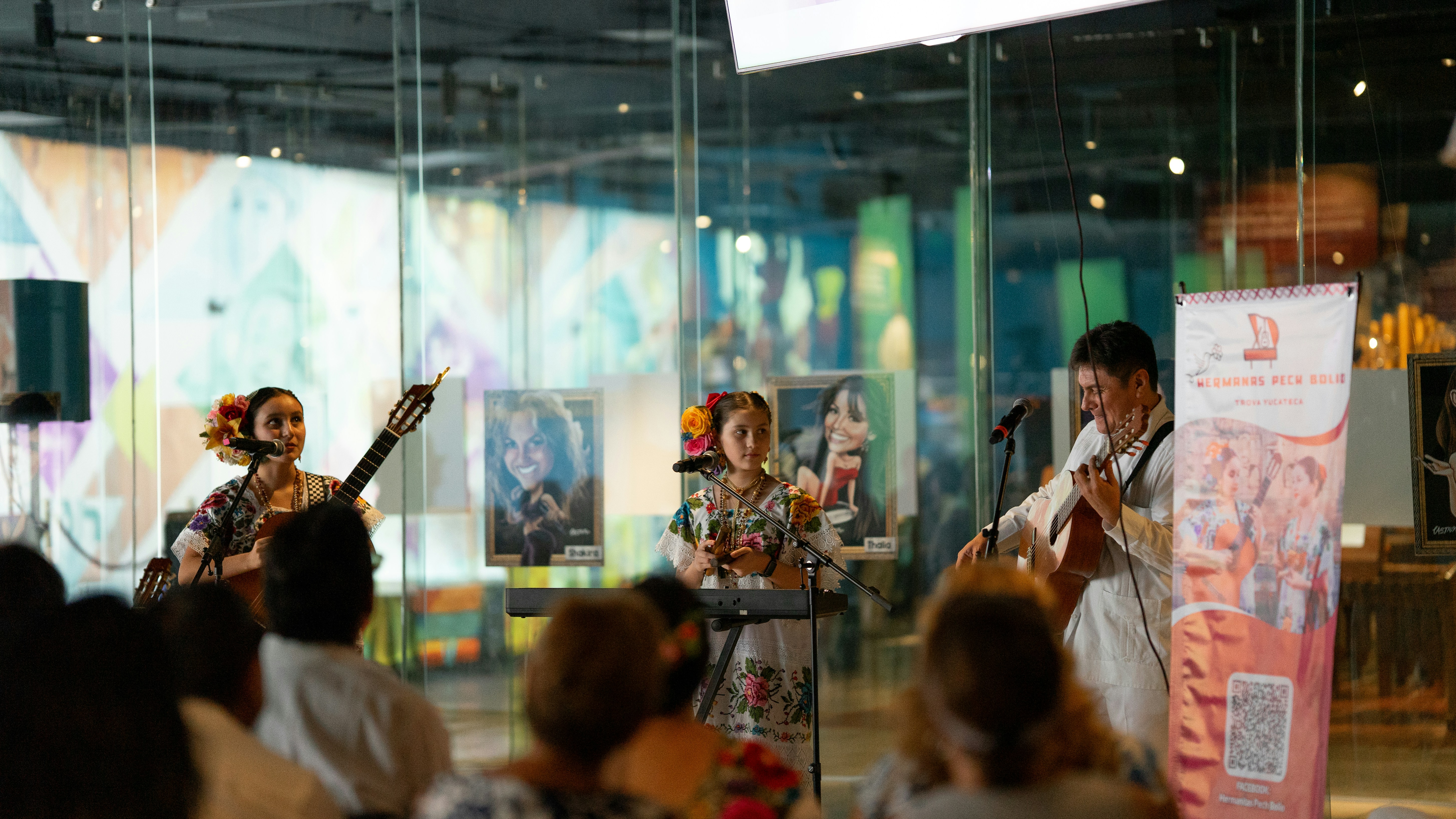 A band performs on stage in front of a crowd.