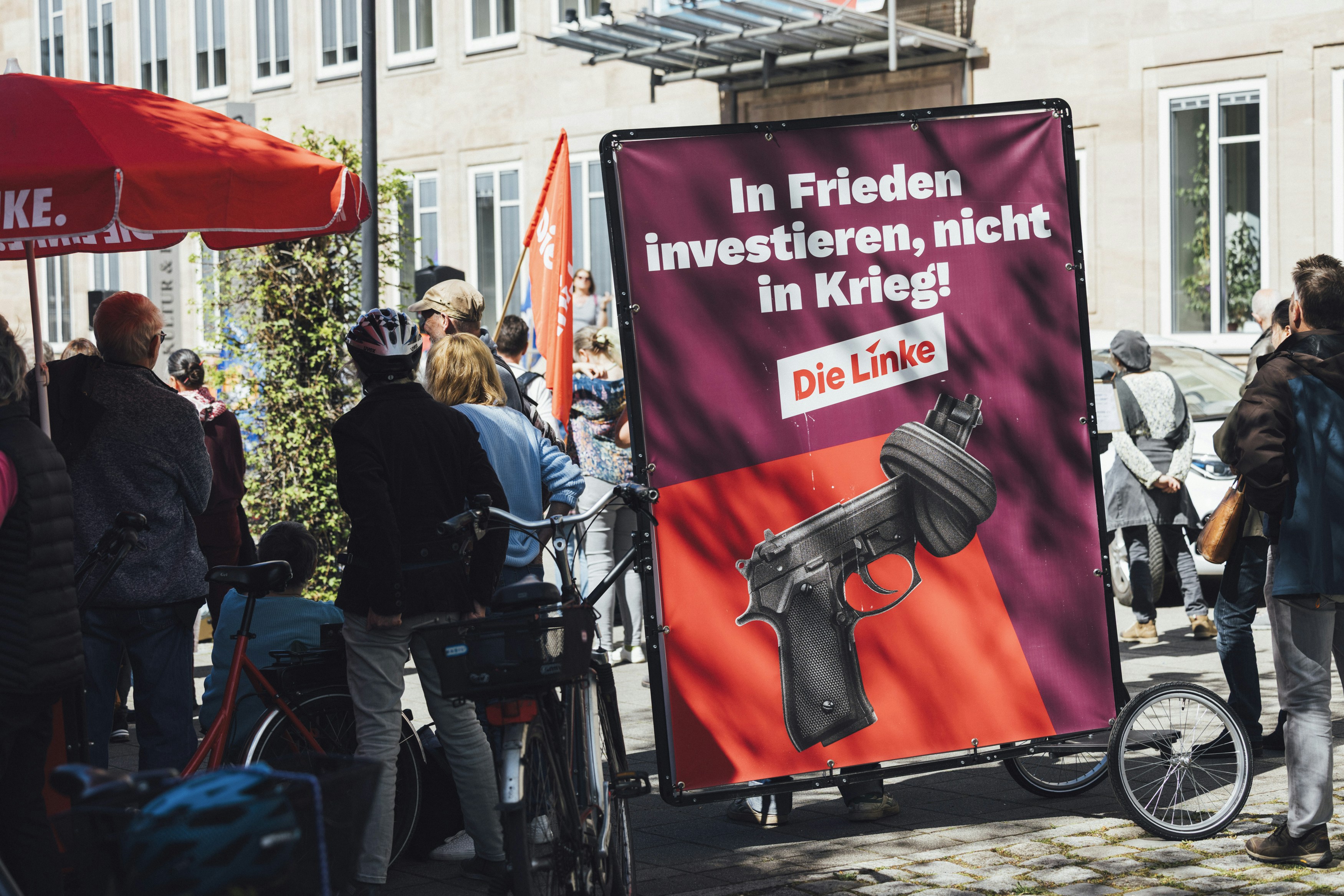 Protestors display a sign against war and for peace.