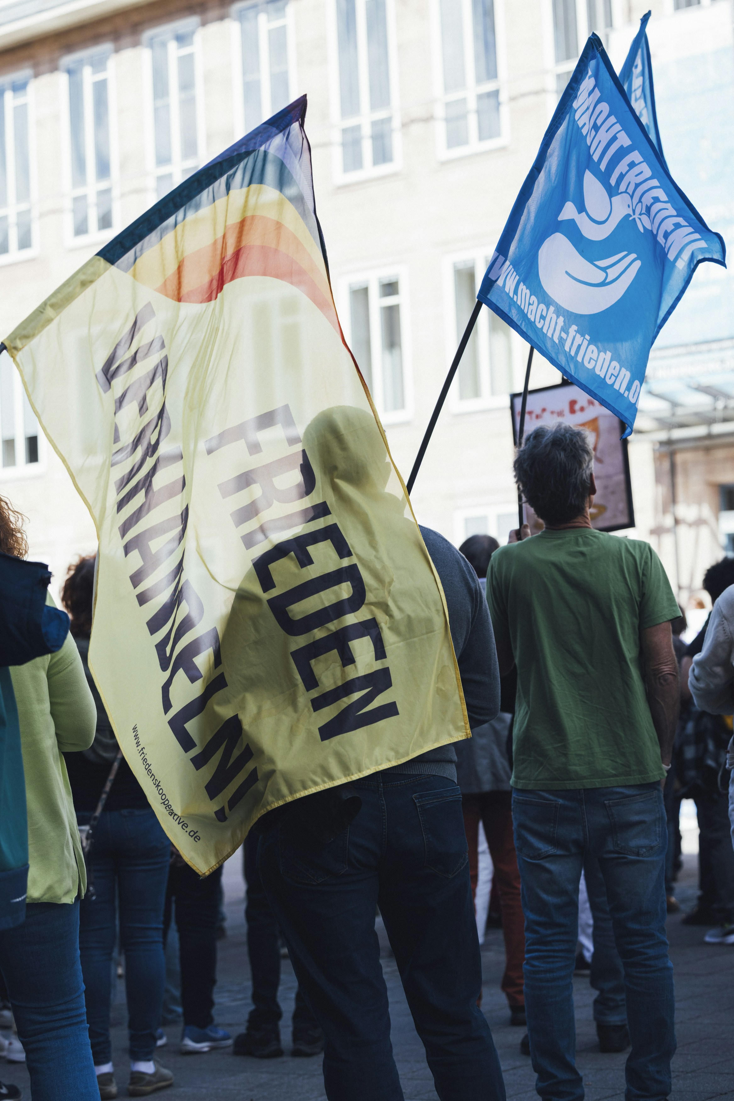 People are protesting for peace with flags.