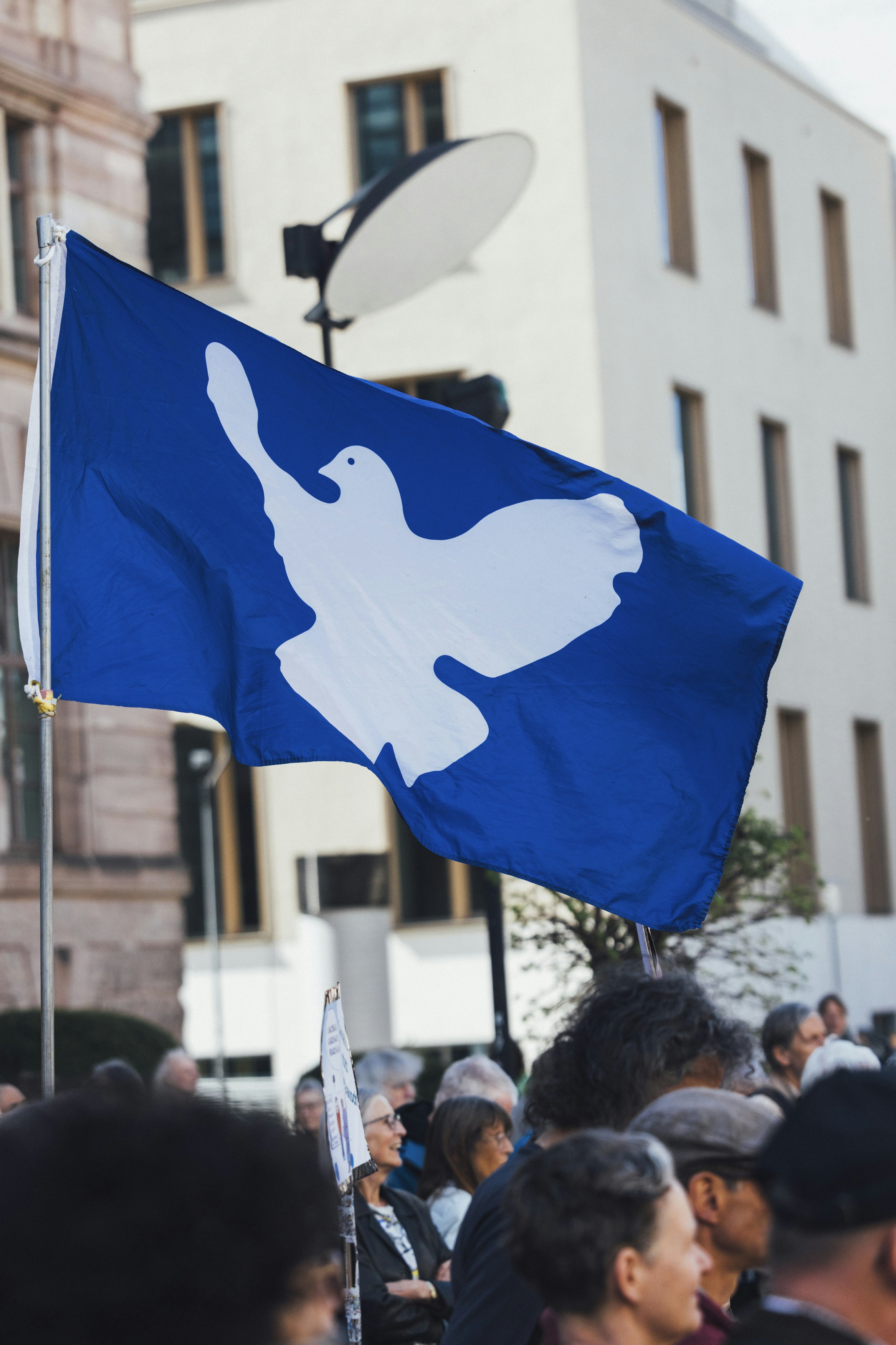 A peace flag with a dove is displayed.