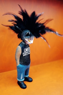 A figure with feathers and a "find yourself" shirt.
