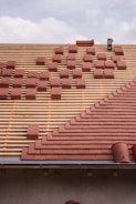Roof under construction, with tiles being laid.