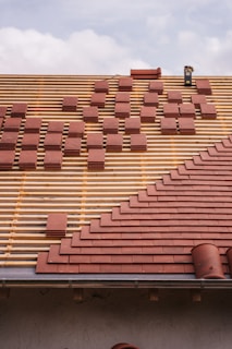 Roof under construction, with tiles being laid.