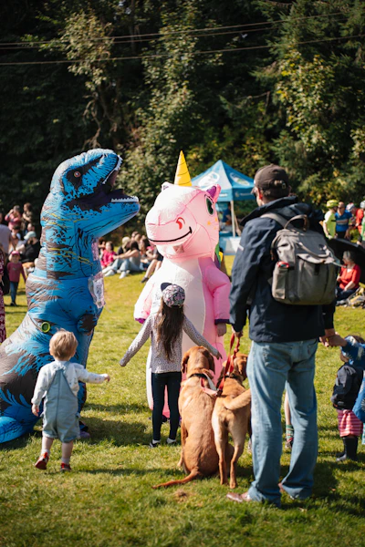 A dinosaur and unicorn attend a festival.