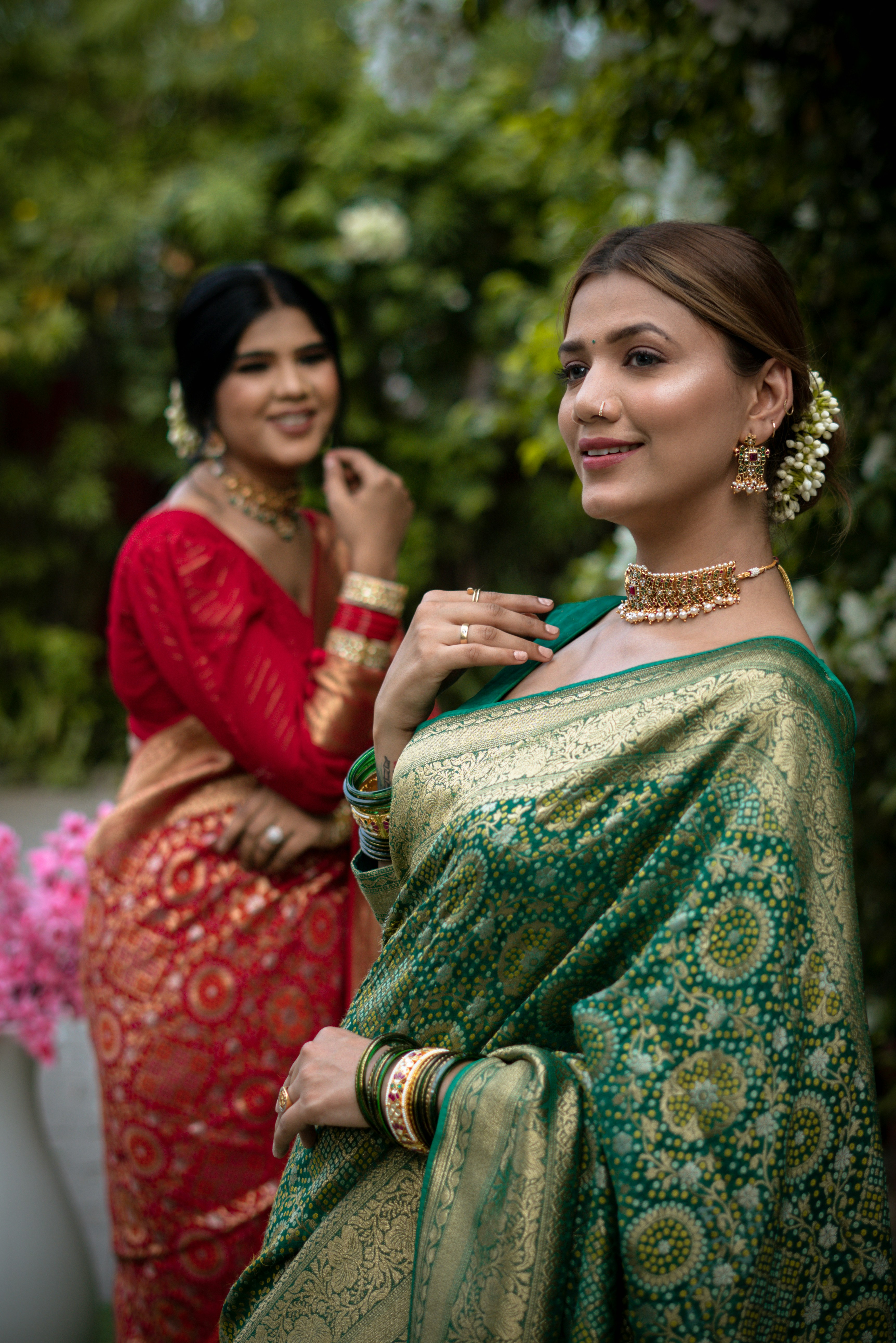 Two women pose in beautiful traditional indian saris.