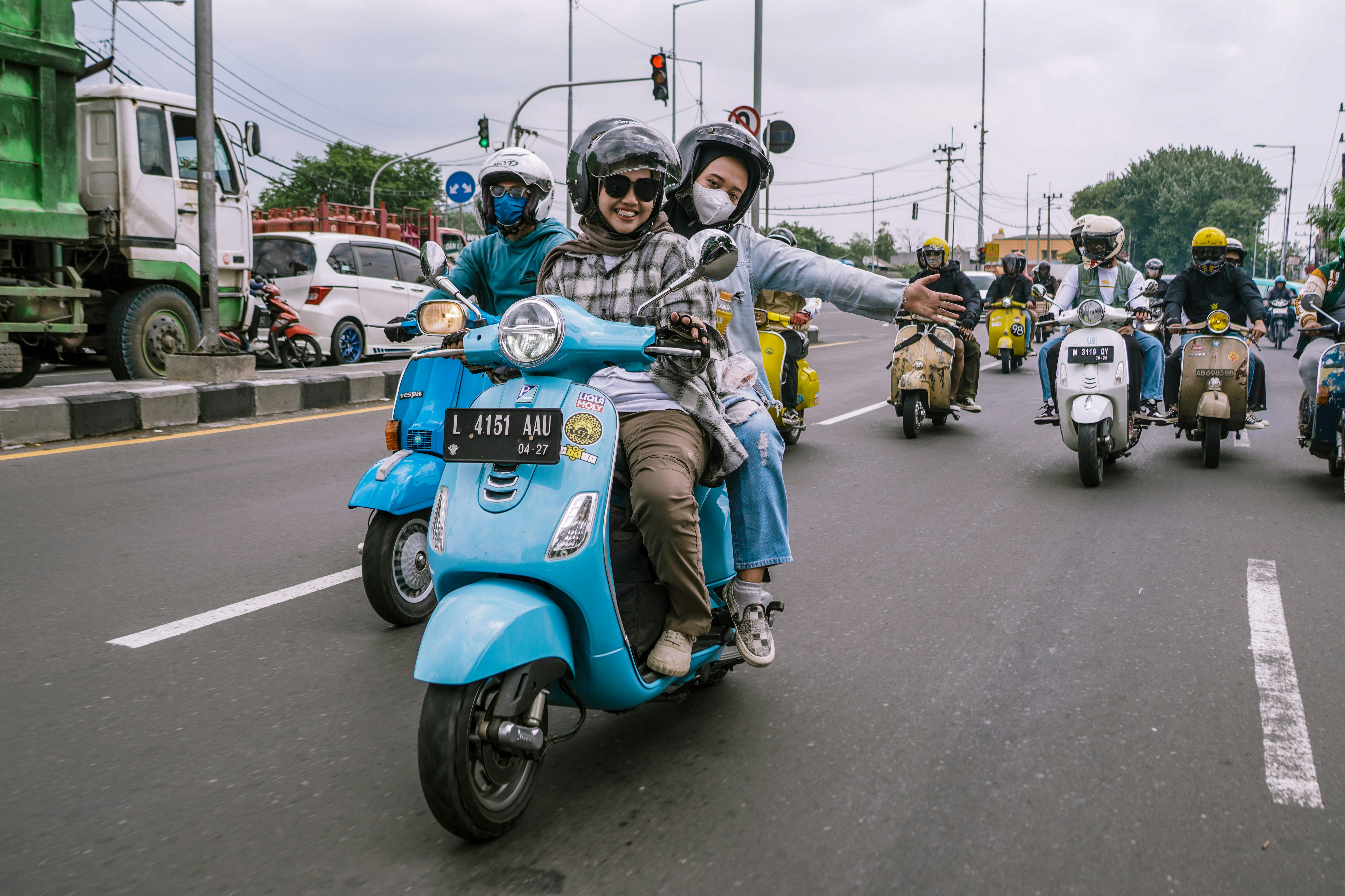 people riding scooters in a city parade