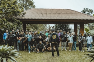 A group of people pose together outdoors.