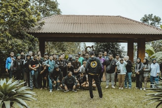 A group of people pose together outdoors.