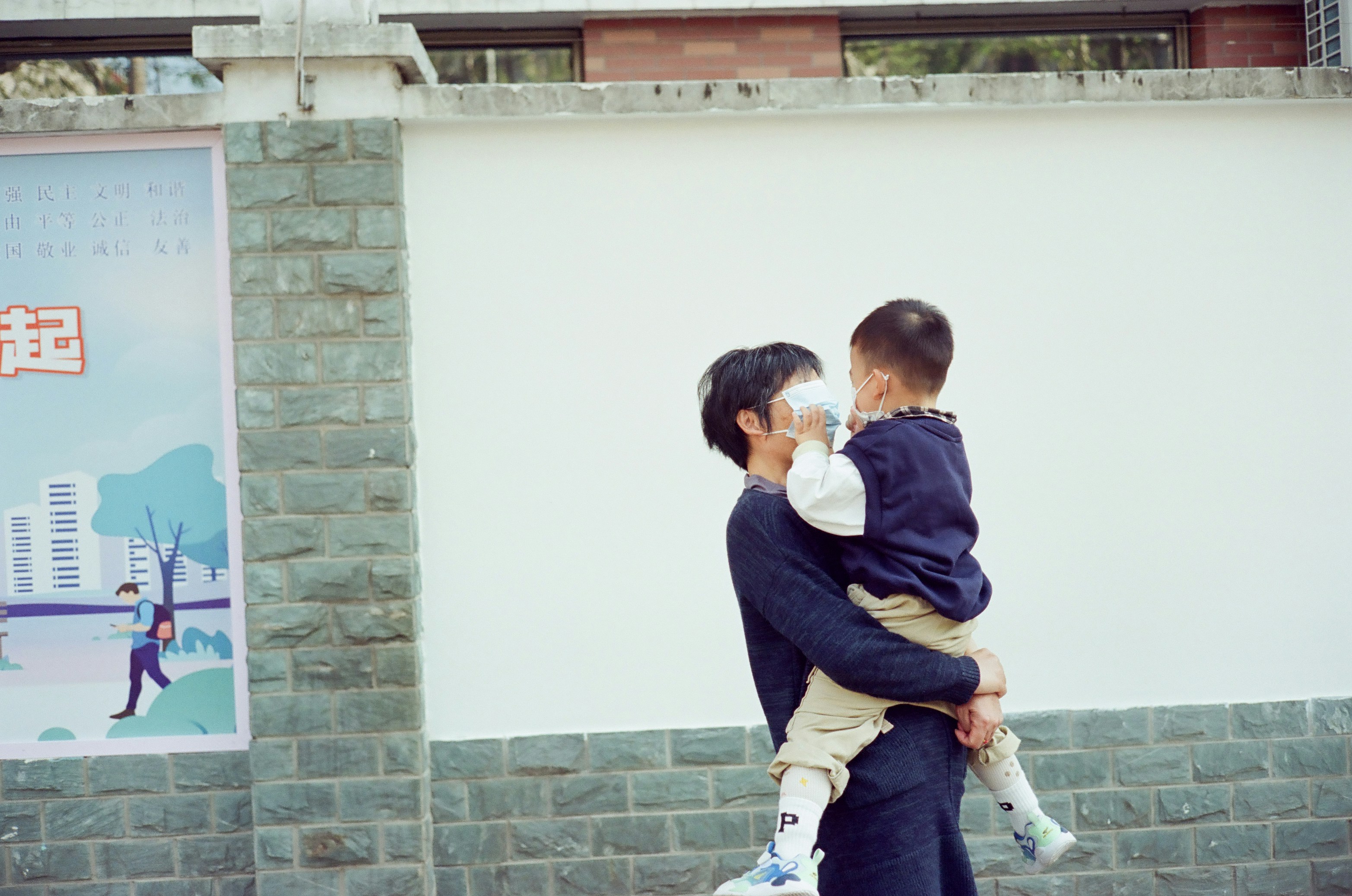 A father holds his child.