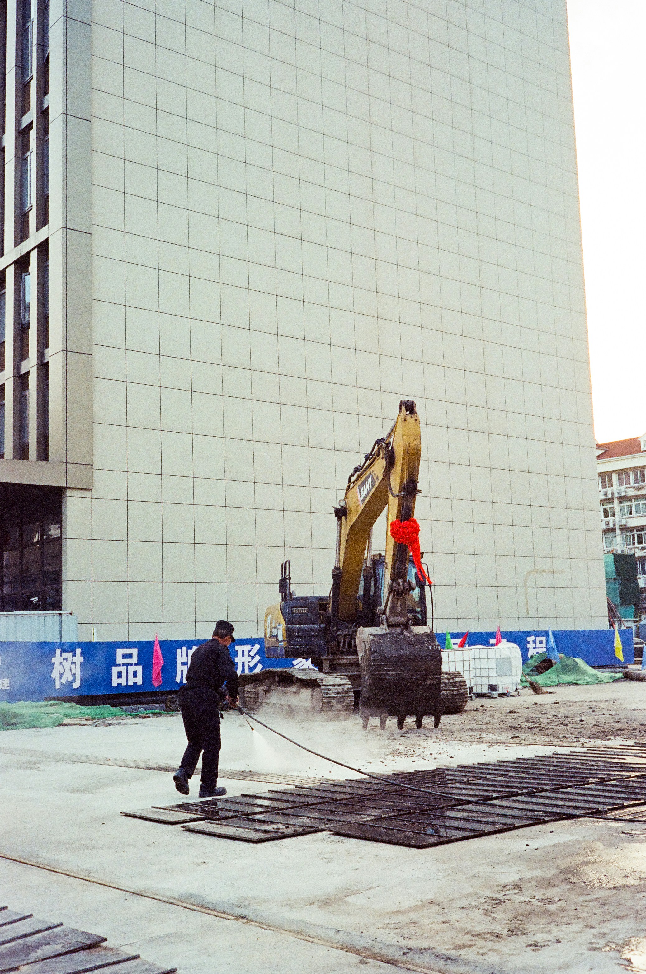 A worker is washing a construction site