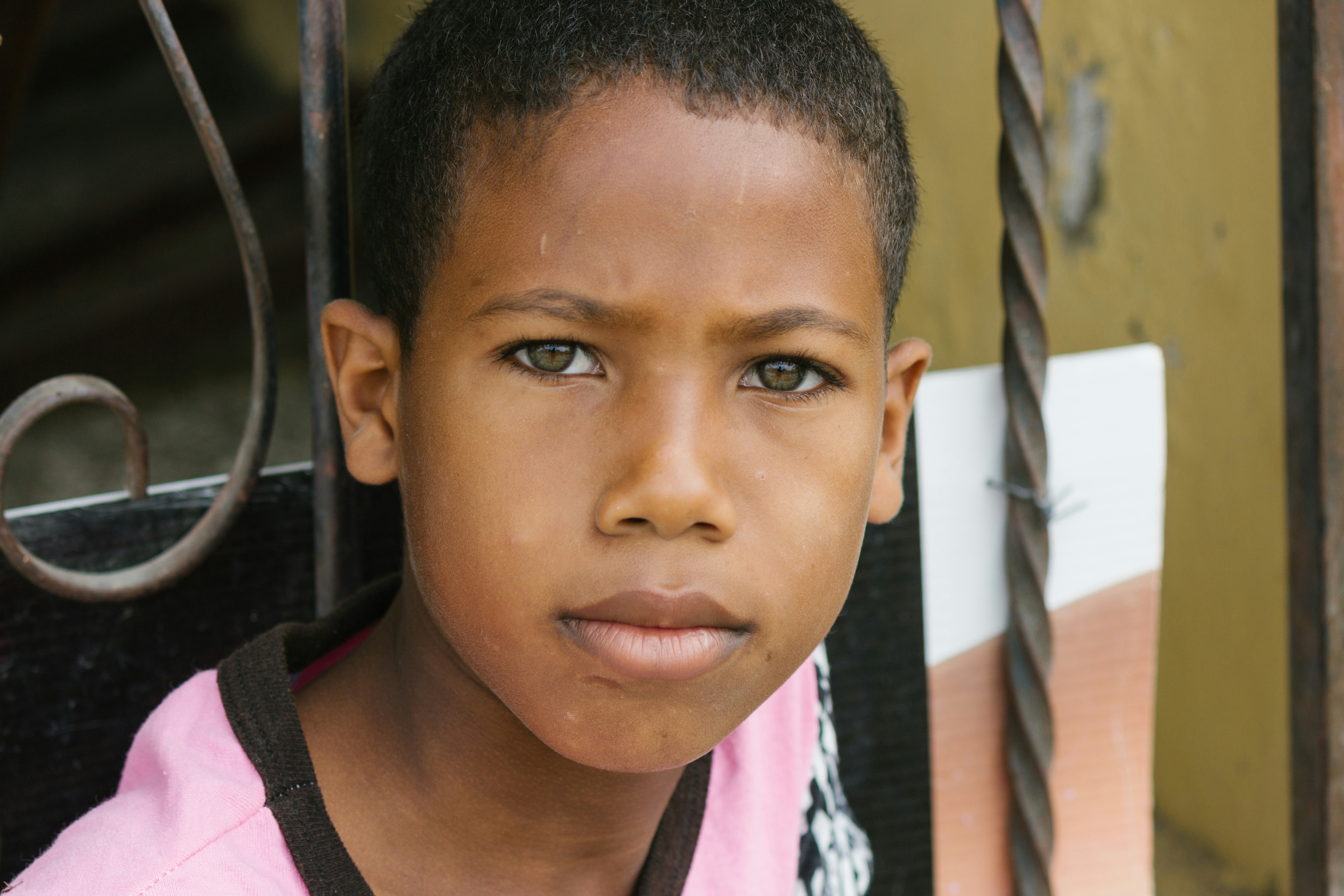 A boy looks directly into the camera.