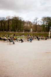 People relax in a park on a cloudy day.