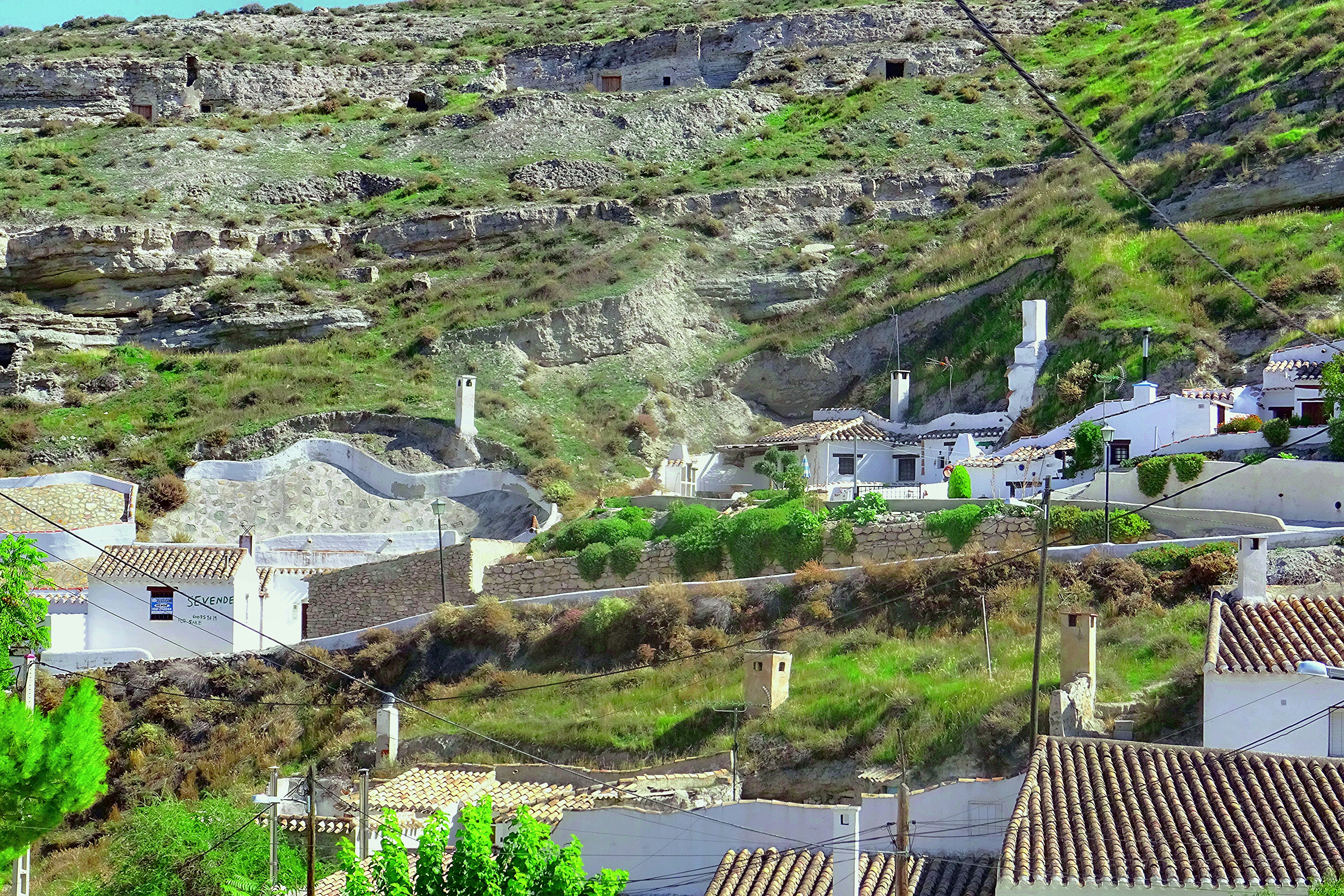 A scenic hillside town with white buildings.