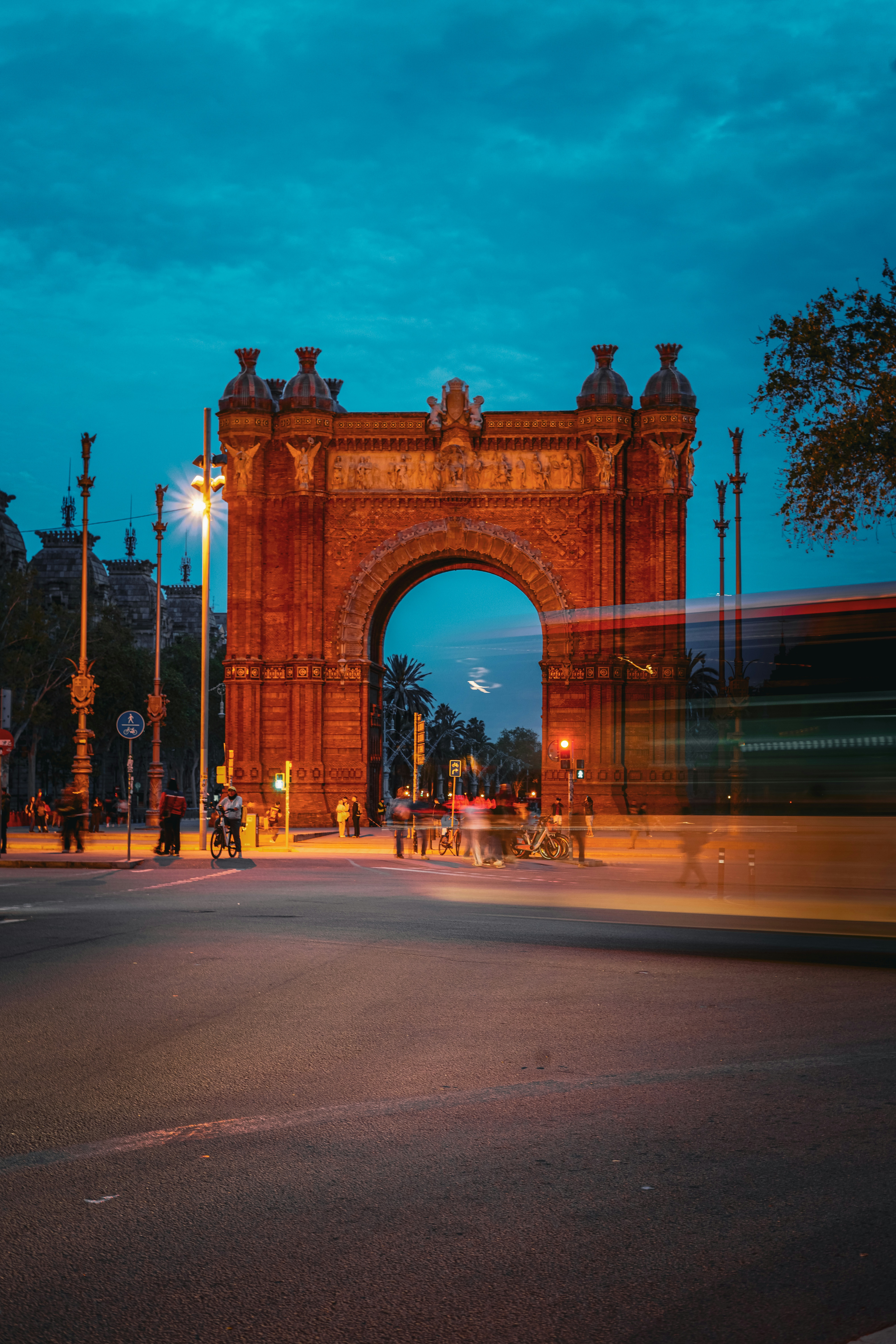 Barcelona's arc de triomf illuminated at dusk.