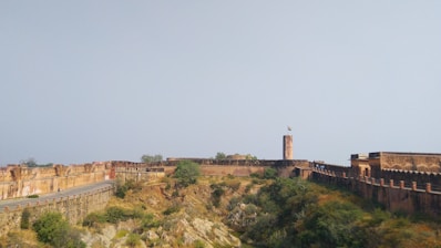 A fort sits atop a hilly landscape.
