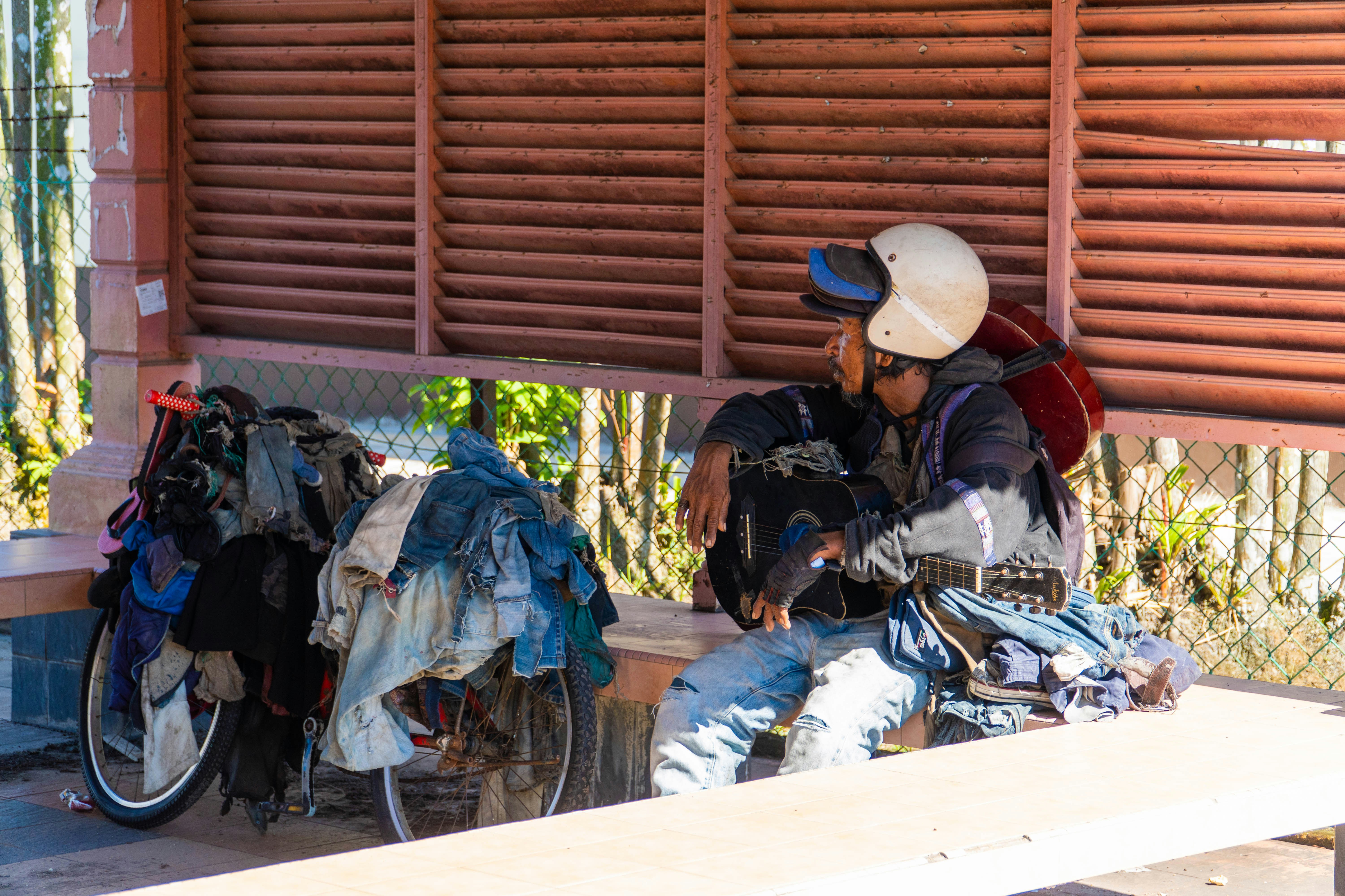 A cyclist rests with their belongings