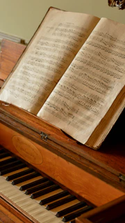 Piano with an open book of musical notes