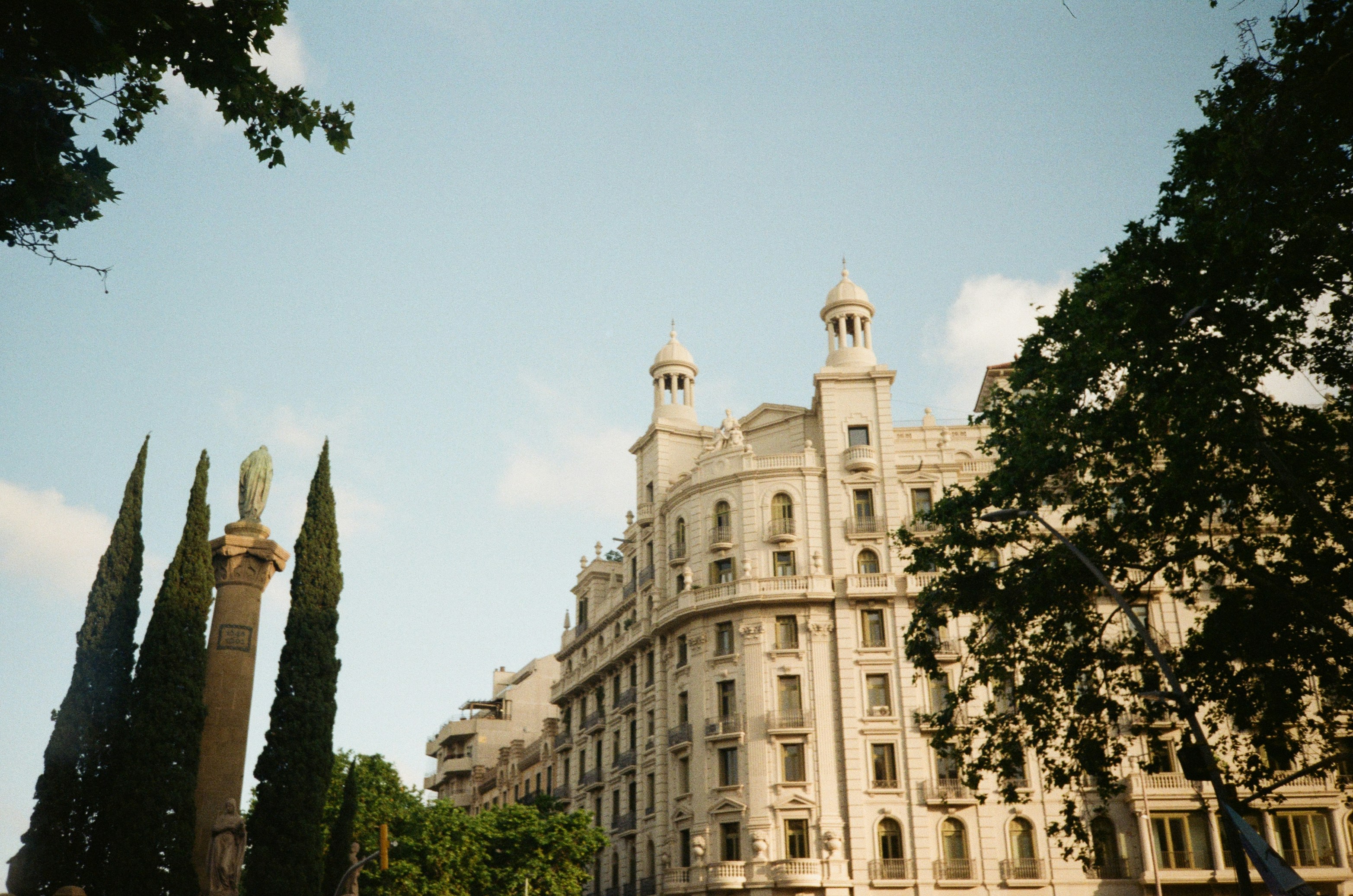 A beautiful building is surrounded by tall trees.