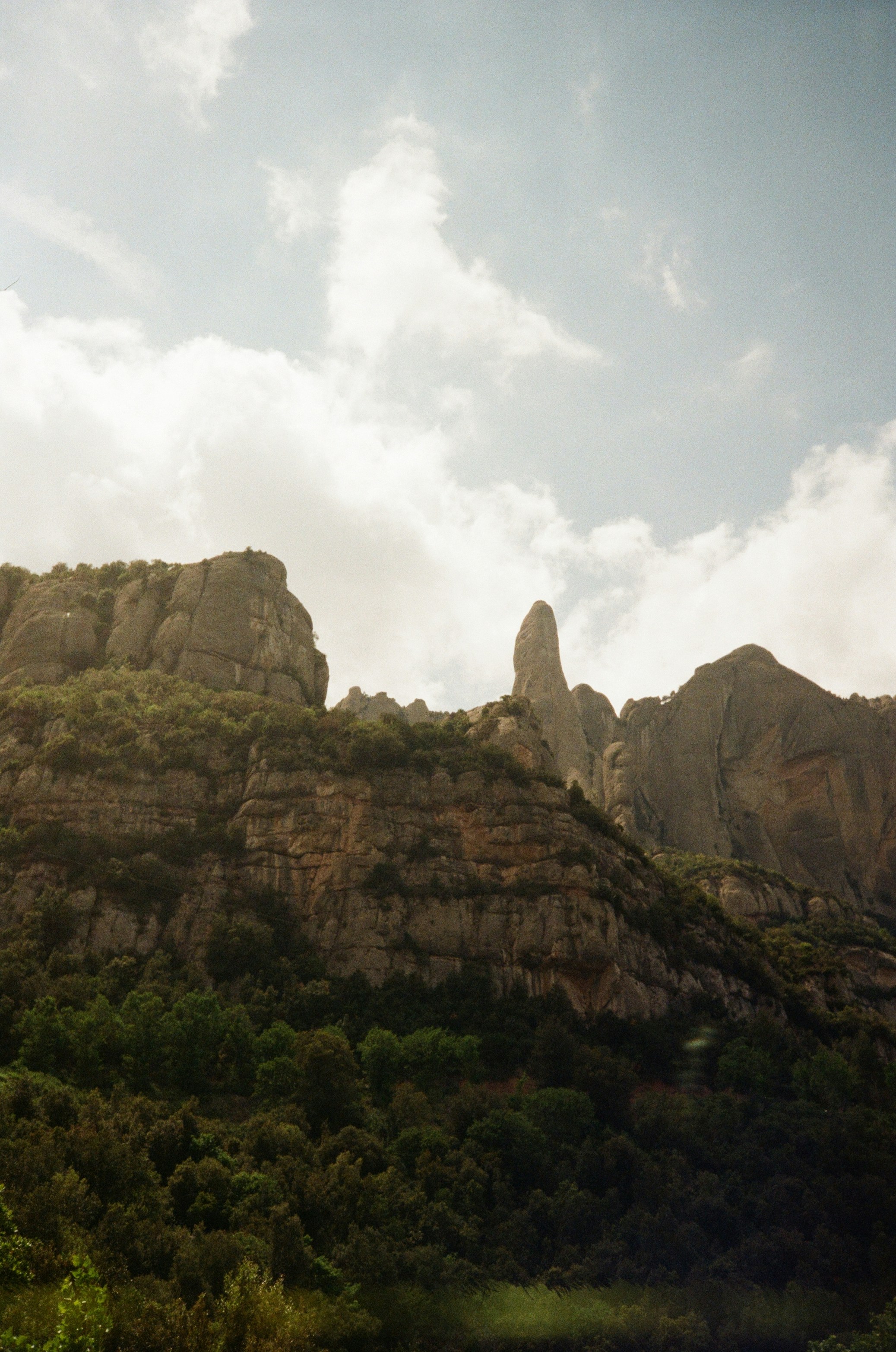 Mountains rise under a cloudy sky.