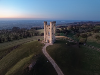 A tower stands proudly atop a hill.