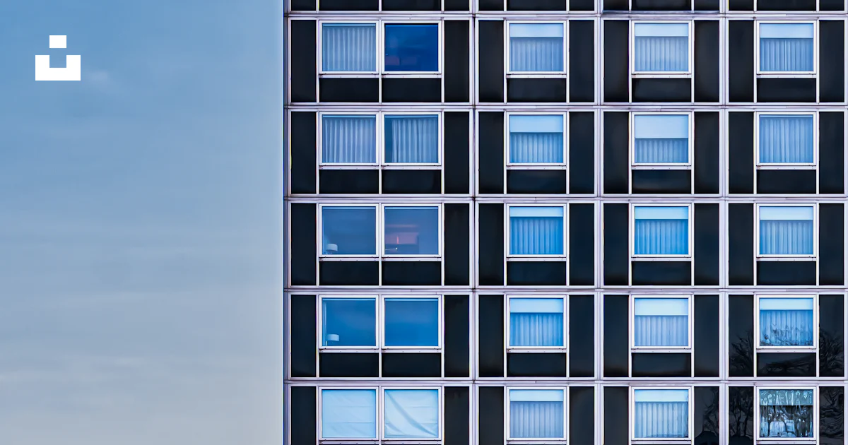 Skyscraper's facade features many windows with a blue sky. photo – Free ...